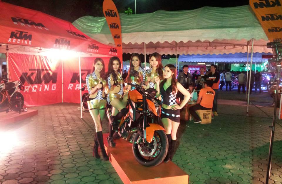 ladies next to a KTM motorbike