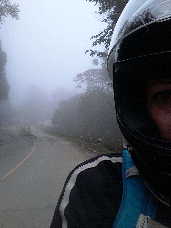 a misty view behind a motorcycle rider