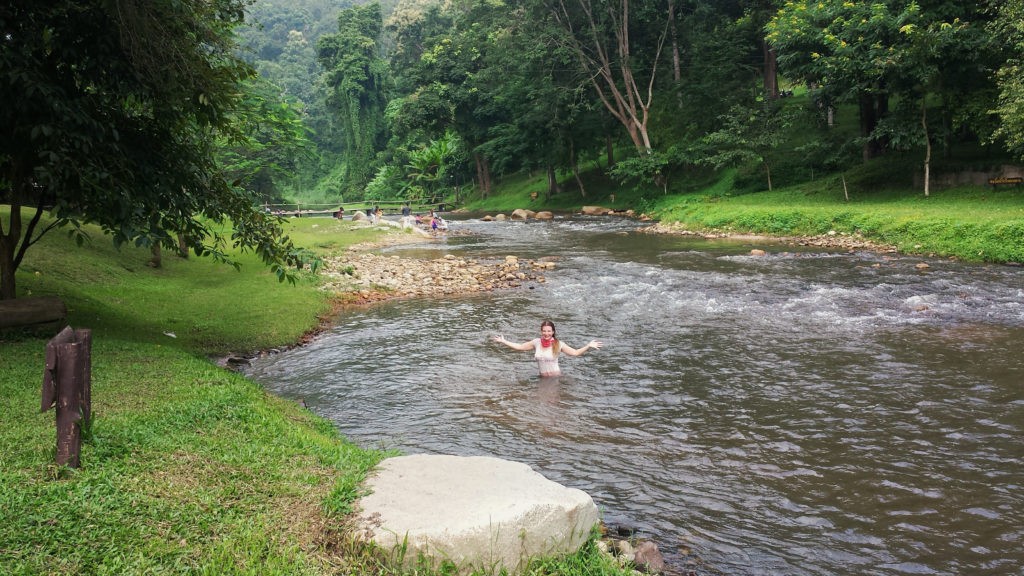 A lady in a river bathing.