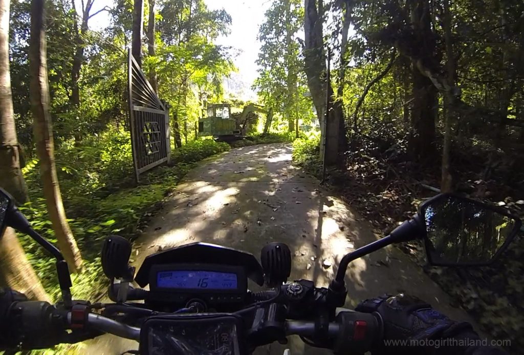 a dirt road leading to a hidden abandoned temple in Thailand