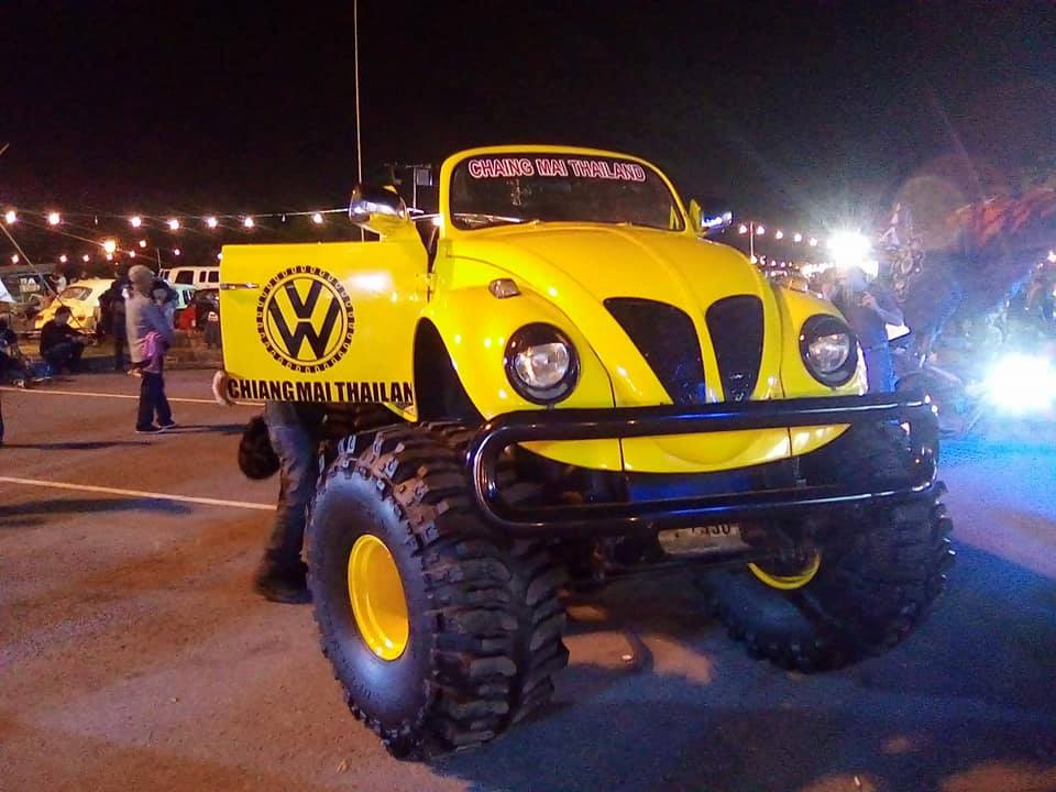 a yellow Monster Truck with off road tires at an evening event. Chiang Mai bike week in Thailand