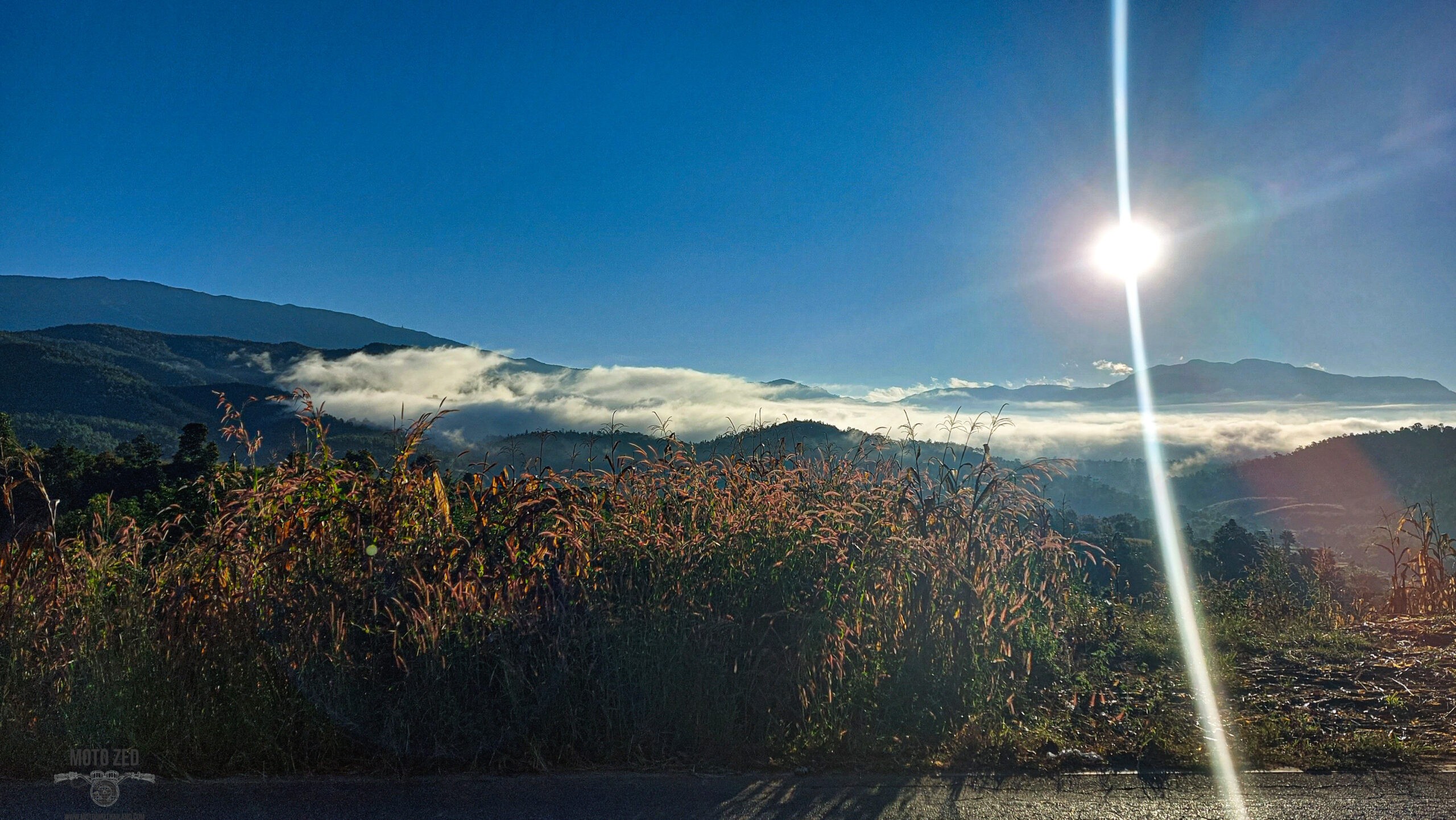 sunbeam and sunlight on a mountain landscape with low thick clouds. Riding to Doi Mae U'Kho